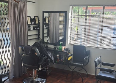 Glam Ink Hair salon with stylish chairs and mirrors in Benoni, Gauteng, ZA.