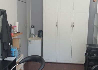 Cozy interior of Glam Ink Hair salon in Benoni, Gauteng, ZA with mirrors and storage units.