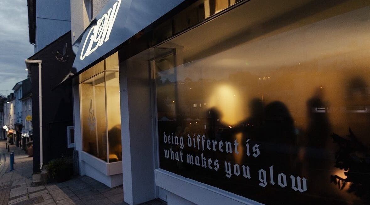 Danielle Hazlewood Beauty's warmly lit exterior in Brixham, England captures an inviting evening glow.