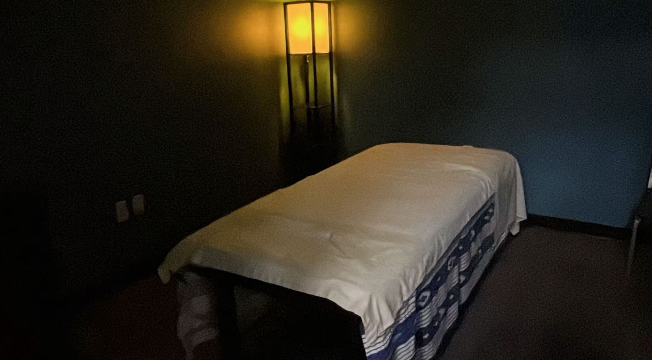 Cozy massage room at Lotus Massage Spa, Chesterfield, Michigan, US, softly lit for relaxation.