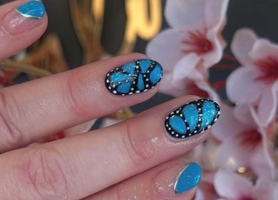 Blue and black butterfly nail art at Palm Springs Hair and Beauty, Margate, England, GB.