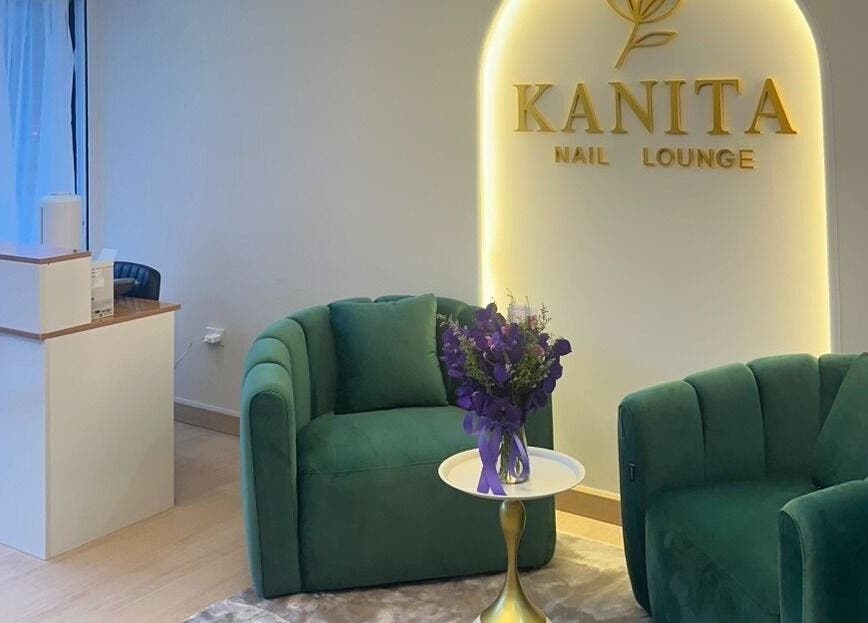Elegant seating at Kanita Nail Lounge, Tambon Hua Hin, Chang Wat Prachuap Khiri Khan, TH, with green chairs and flowers.
