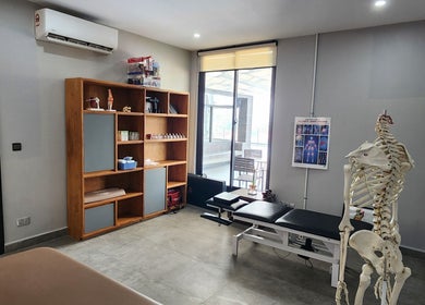 Tranquil physiotherapy room at Go Gym, Phnom Penh, Phnom Penh, KH, showcasing equipment and an anatomical model.