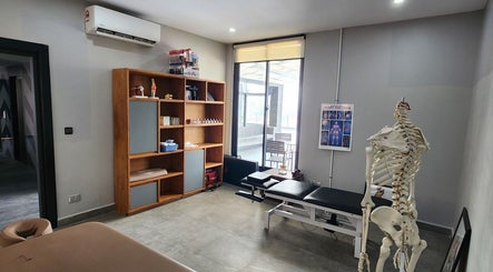 Tranquil physiotherapy room at Go Gym, Phnom Penh, Phnom Penh, KH, showcasing equipment and an anatomical model.