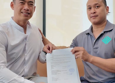 Two individuals celebrating a partnership signing at Go gym, Phnom Penh, Phnom Penh, KH.