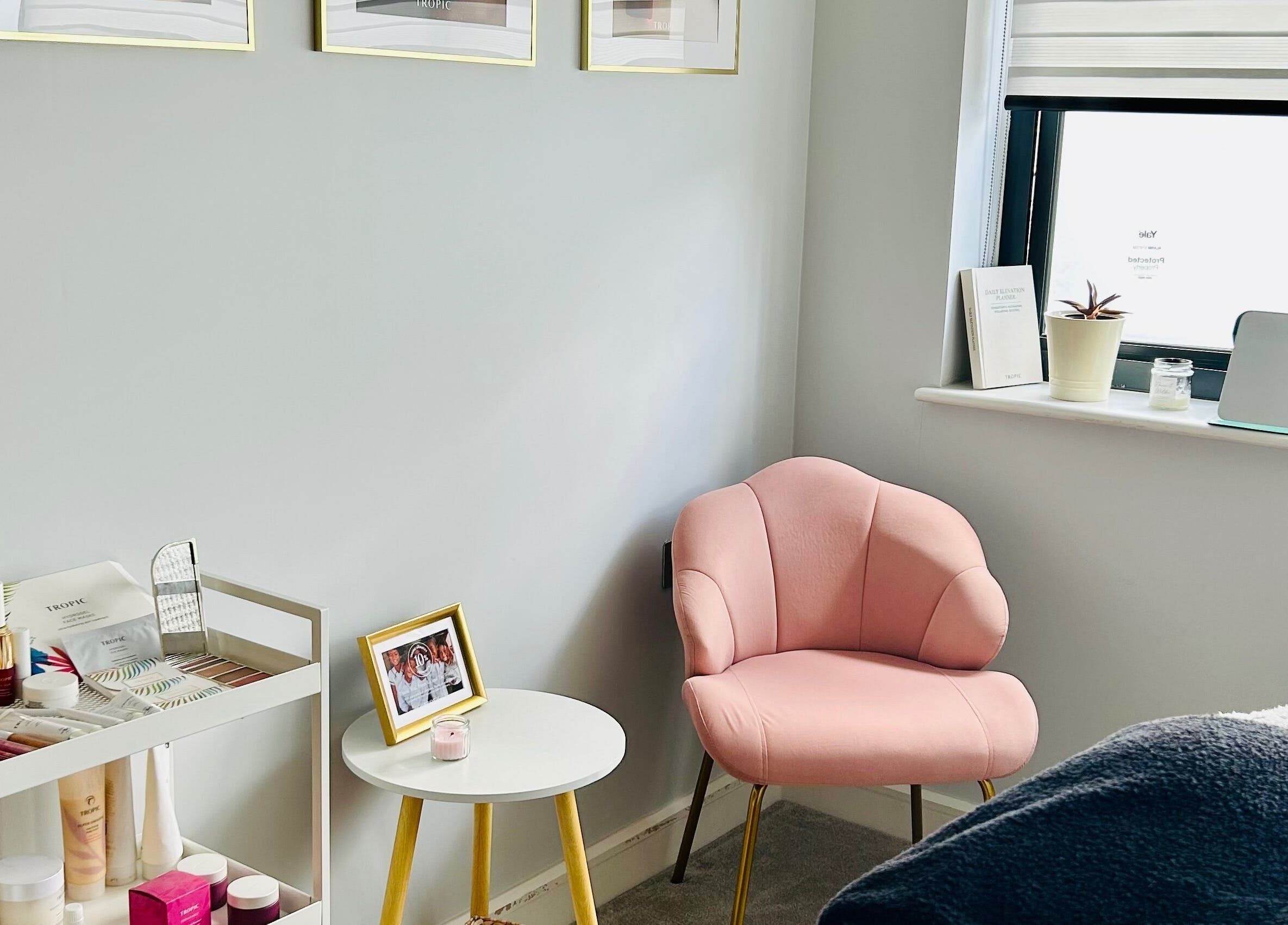 Cozy corner at VF Skincare & Facials with pink chair and skincare products in Winchester, England, GB.