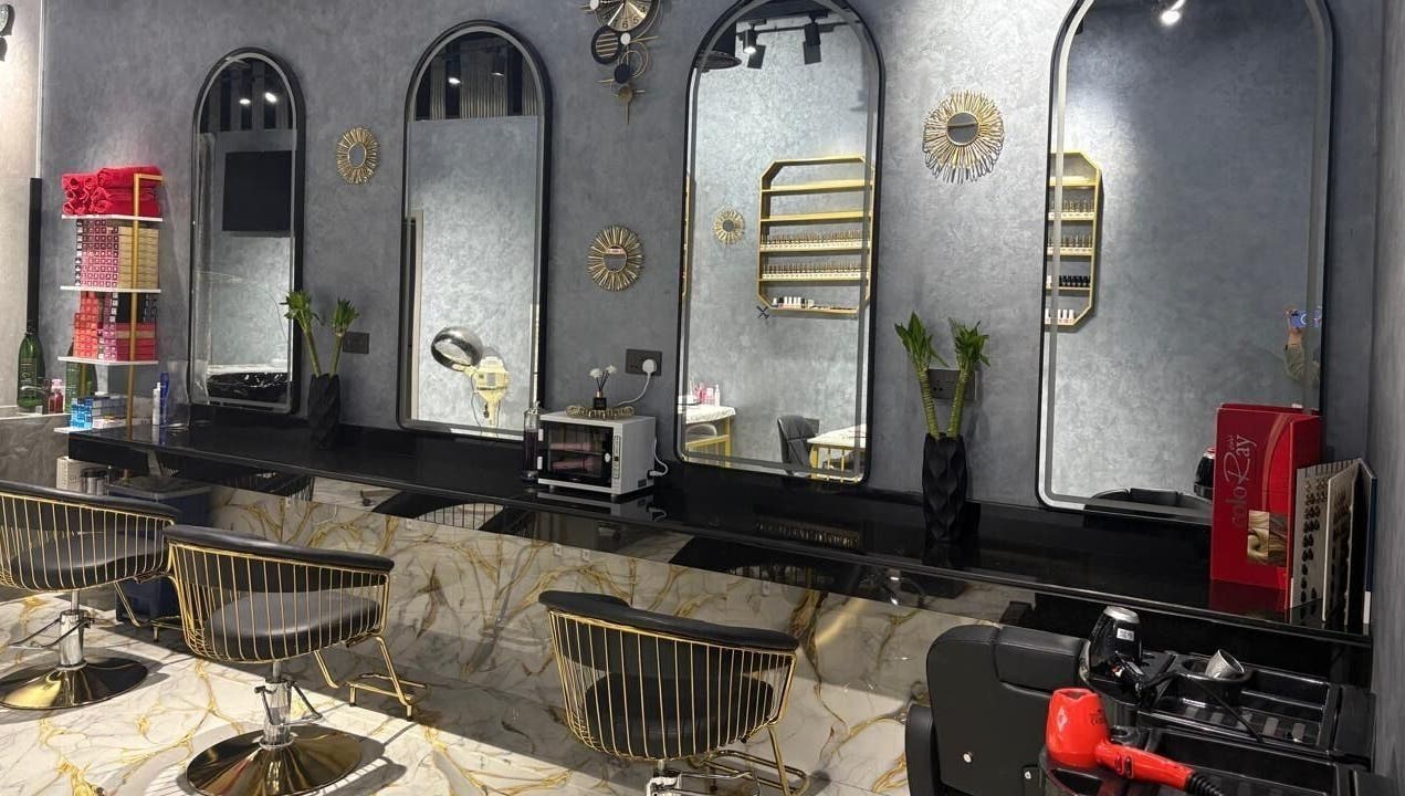Modern chic salon interior at Lamasat Al Yasmin Beauty Salon, Dubai, Dubai, AE, featuring sleek mirrors and stylish chairs.