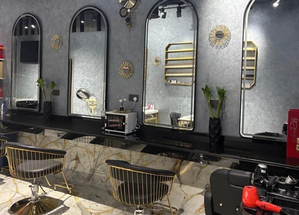 Modern chic salon interior at Lamasat Al Yasmin Beauty Salon, Dubai, Dubai, AE, featuring sleek mirrors and stylish chairs.