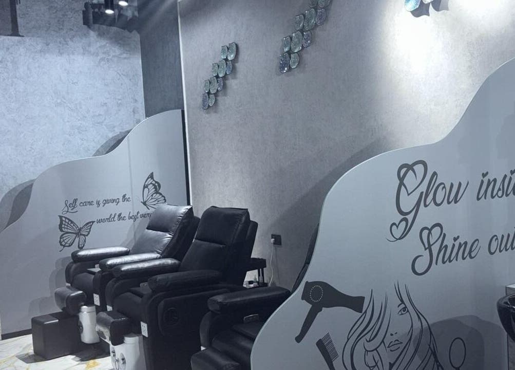 Relaxing pedicure chairs at Lamasat Al Yasmin Beauty Salon, Dubai, Dubai, AE with elegant wall art.