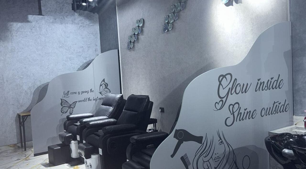 Relaxing pedicure chairs at Lamasat Al Yasmin Beauty Salon, Dubai, Dubai, AE with elegant wall art.