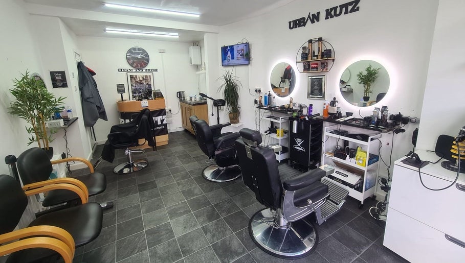 Interior of Urban Kutz in Stretford, England, GB. Modern barber chairs and stylish décor.