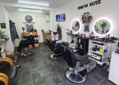 Interior of Urban Kutz in Stretford, England, GB. Modern barber chairs and stylish décor.