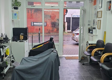 Modern interior of Urban Kutz, Stretford, England, GB. Stylish seating and equipment for a premium barber experience.
