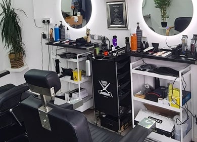 Grooming chairs and tools at Urban Kutz, Stretford, England, GB, showcasing modern barber setup.