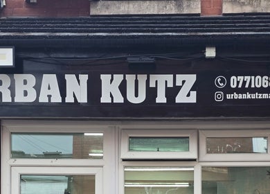 Urban Kutz signage displaying contact info in Stretford, England, GB.