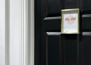 Entrance to ByKG Lashes & Brows in Swords, County Dublin, IE with elegant black door and signage.