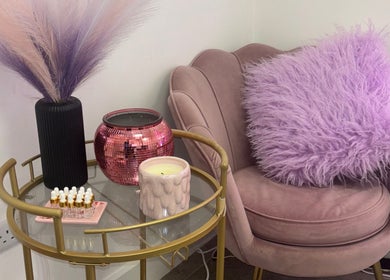 Cozy seating area at ByKG Lashes & Brows, Swords, County Dublin, IE with lavender hues and chic decor.