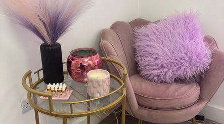 Cozy seating area at ByKG Lashes & Brows, Swords, County Dublin, IE with lavender hues and chic decor.