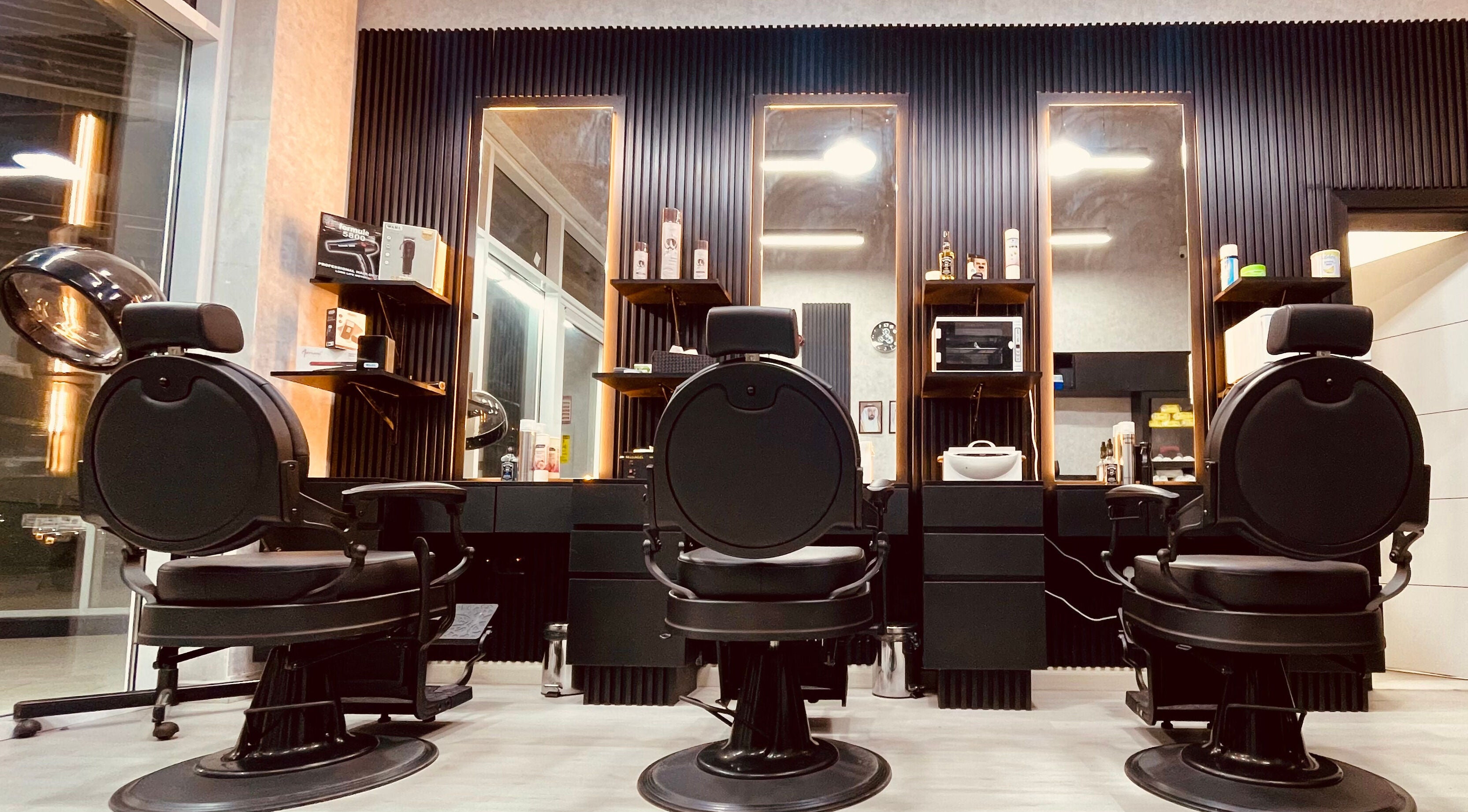 Stylish barber chairs at Sharp Touch Gents Salon, Sharjah, إمارة الشارقةّ, AE, in a sleek, modern setting.