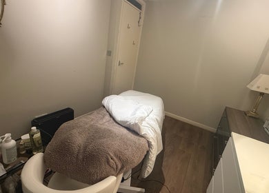 Cozy massage room at You Beauty, Bathgate, Scotland, GB featuring a treatment table and soothing ambiance.