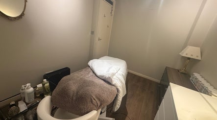 Cozy massage room at You Beauty, Bathgate, Scotland, GB featuring a treatment table and soothing ambiance.