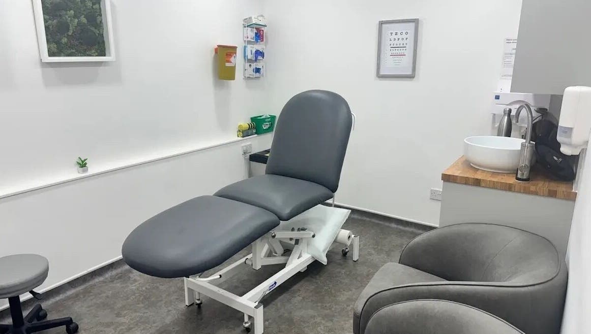Modern treatment room at Serene Skin Lounge, Waterloo, England, GB with sleek gray furnishings.