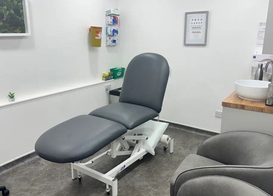 Modern treatment room at Serene Skin Lounge, Waterloo, England, GB with sleek gray furnishings.