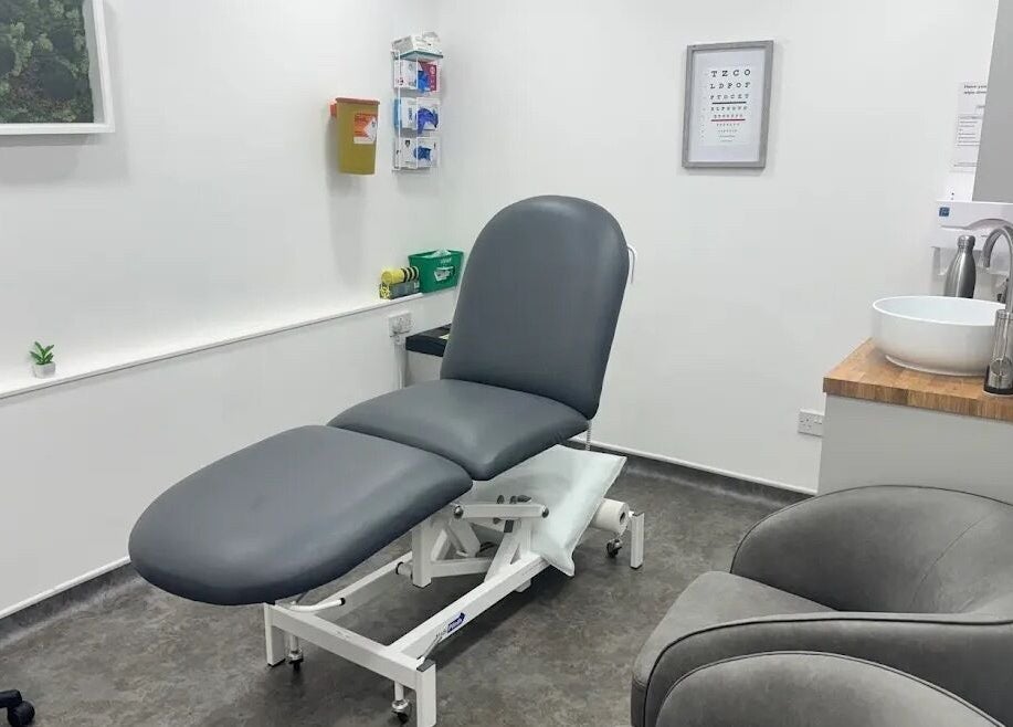 Modern treatment room at Serene Skin Lounge, Waterloo, England, GB with sleek gray furnishings.
