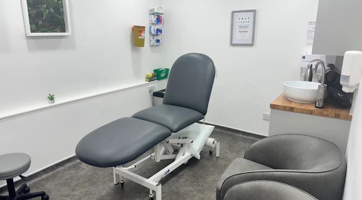 Modern treatment room at Serene Skin Lounge, Waterloo, England, GB with sleek gray furnishings.