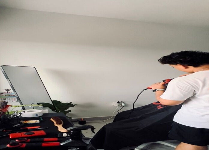 Stylish hairdresser at work in Hairbreed Society studio, Cyberjaya, Selangor, MY.