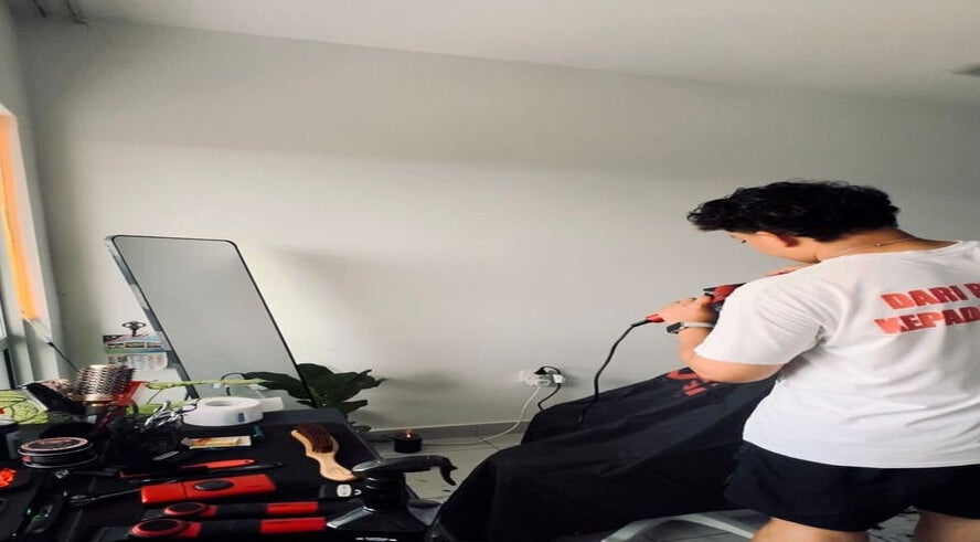 Stylish hairdresser at work in Hairbreed Society studio, Cyberjaya, Selangor, MY.