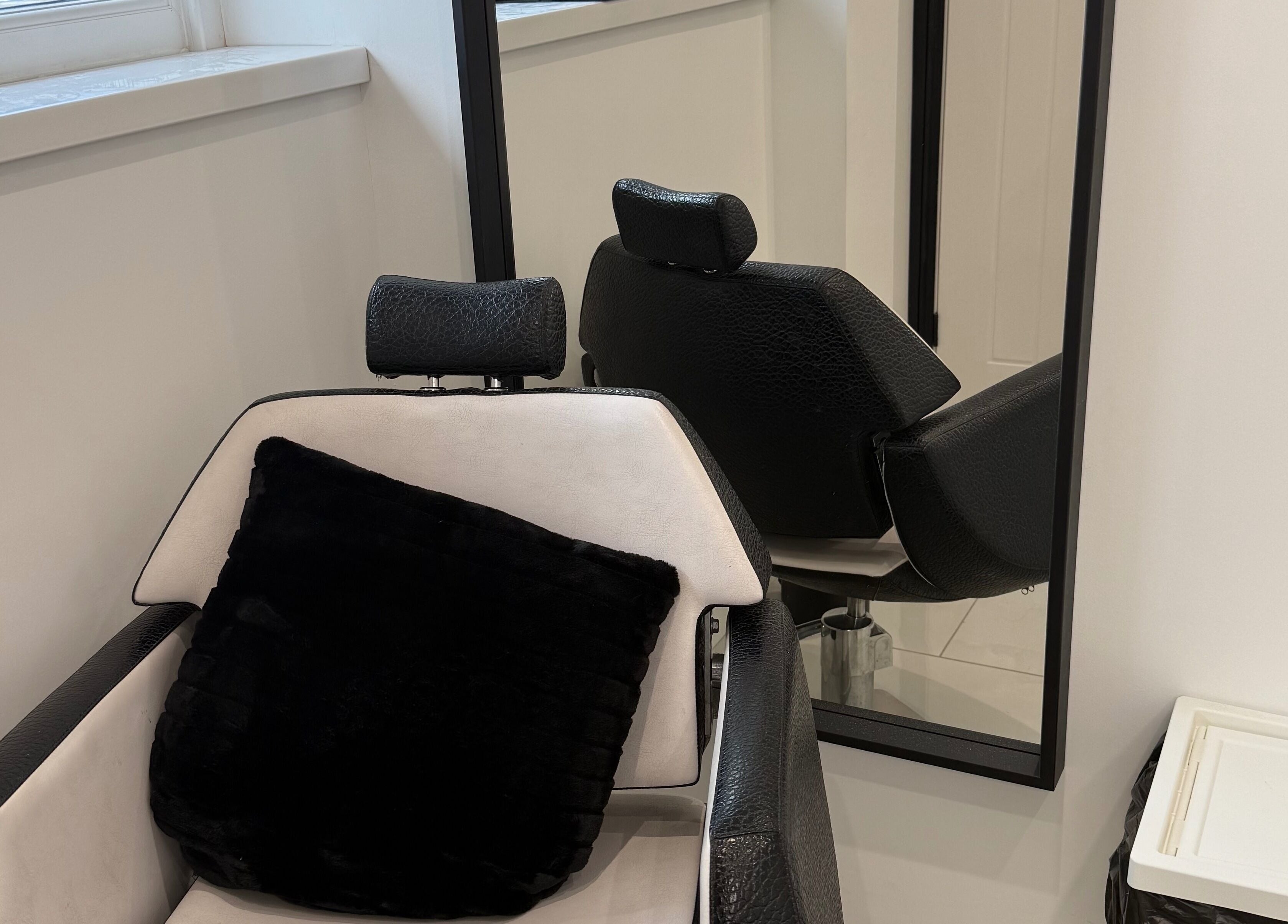 Elegant salon chair at Modern Beauty, Newport, Wales, GB with plush pillow, reflecting relaxation and comfort.