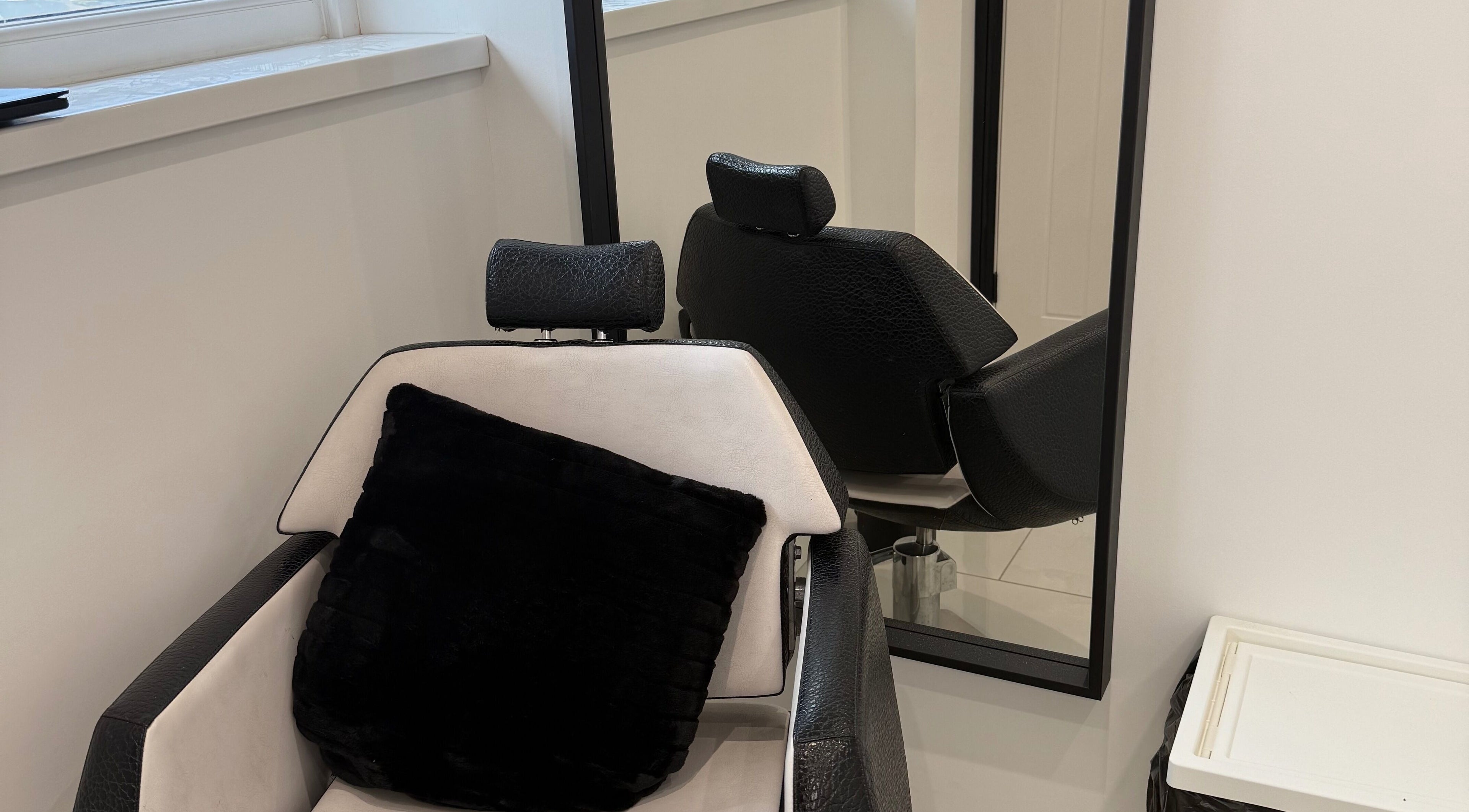 Elegant salon chair at Modern Beauty, Newport, Wales, GB with plush pillow, reflecting relaxation and comfort.