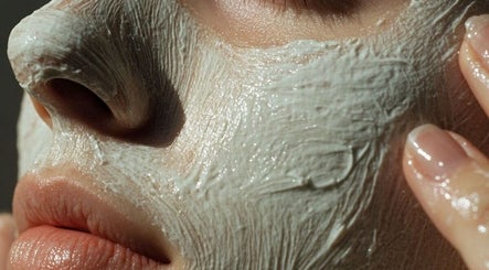 Smooth clay mask gently applied to face at Renew by Emily Leed, Long Ditton, England, GB for a radiant glow.