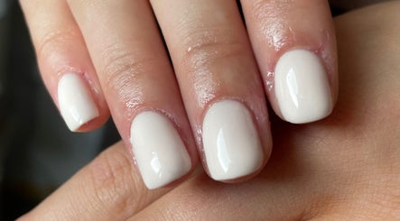 Elegant ivory manicure at Ash & Ember Beauty, Lerwick, Scotland, GB, showcasing precise nail artistry.