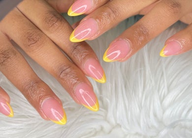 Stylish yellow-tipped nails crafted at Wino'S Nail Pub, Gaborone, Gaborone City, BW on a plush white background.