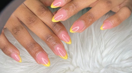 Stylish yellow-tipped nails crafted at Wino'S Nail Pub, Gaborone, Gaborone City, BW on a plush white background.