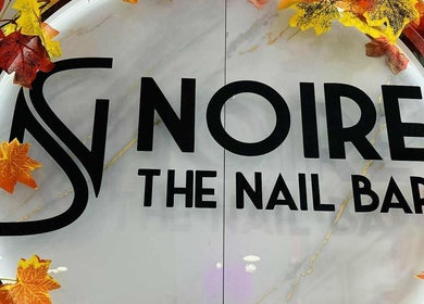 Autumn-themed entrance at Noire The Nail Bar - Bell Tower Shop, Fort Myers, FL, US.