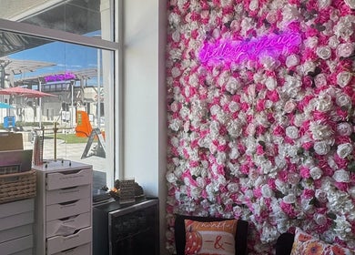 Chic flower wall and bright decor at Noire The Nail Bar - Bell Tower Shop in Fort Myers, FL, US.