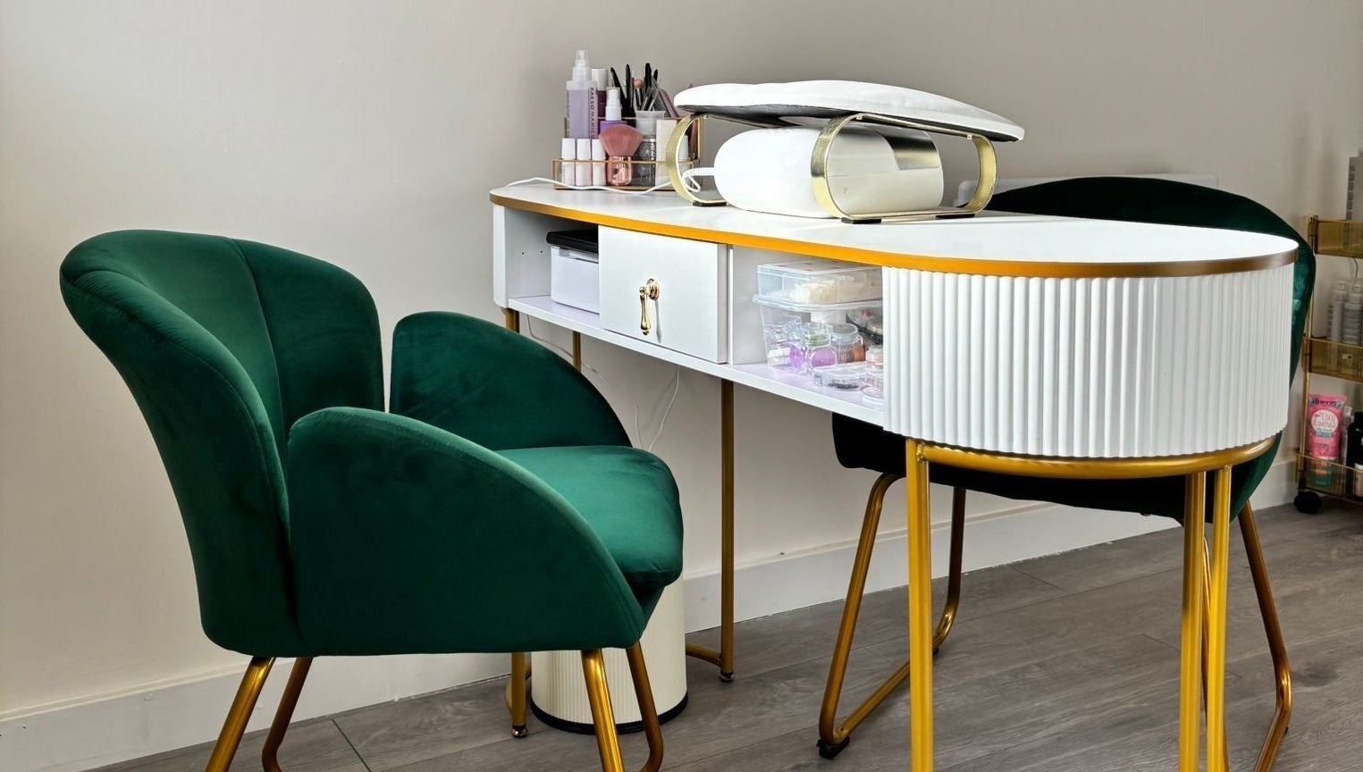 Sophisticated nail station at The Beauty Space by Katie Bancroft, Leicester, England, GB, with plush green chairs.
