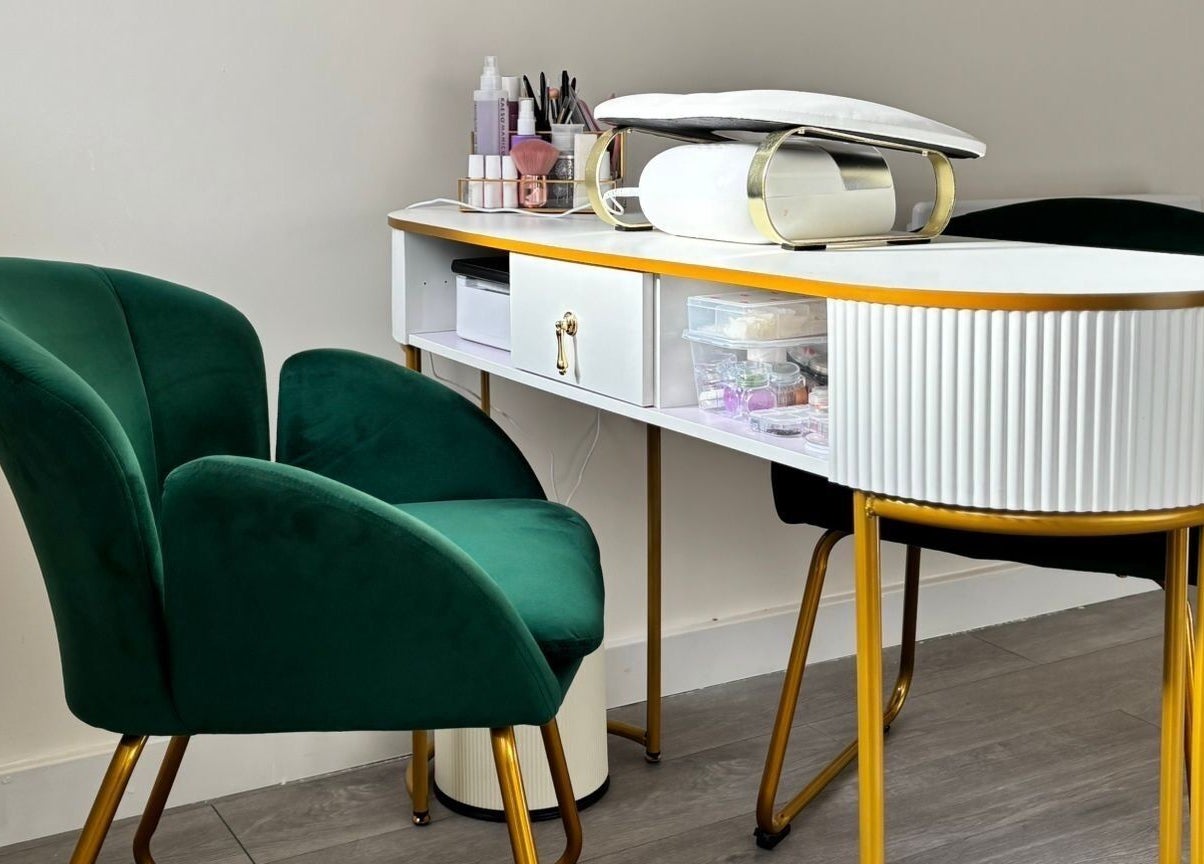 Sophisticated nail station at The Beauty Space by Katie Bancroft, Leicester, England, GB, with plush green chairs.