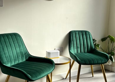Elegant green chairs in the serene waiting area of The Beauty Space by Katie Bancroft, Leicester, England, GB.