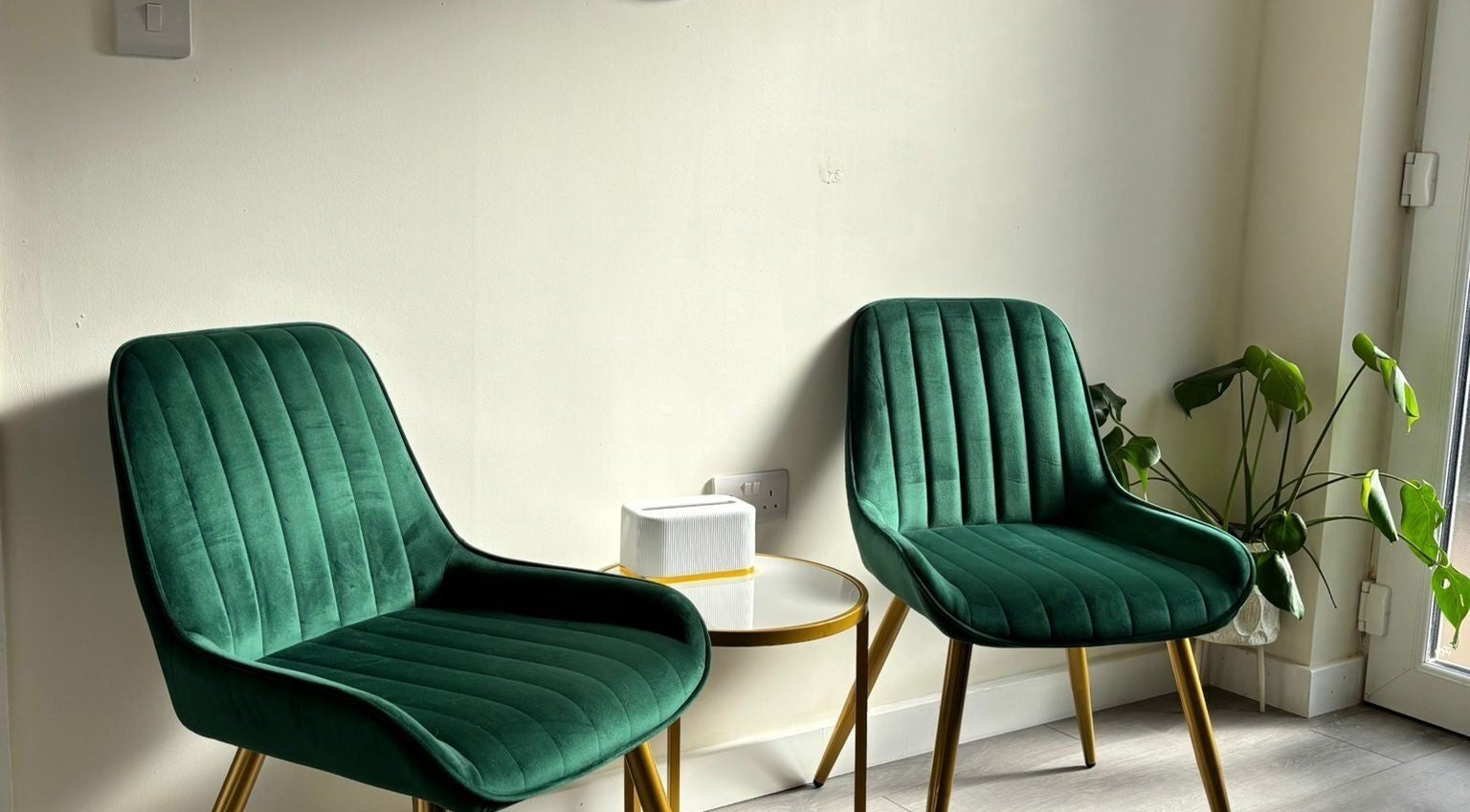 Elegant green chairs in the serene waiting area of The Beauty Space by Katie Bancroft, Leicester, England, GB.