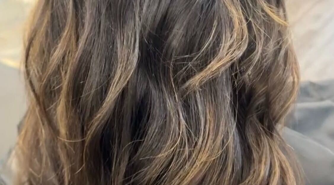 Flowing brunette hair with highlights at River & Root, Avon, Indiana, US.