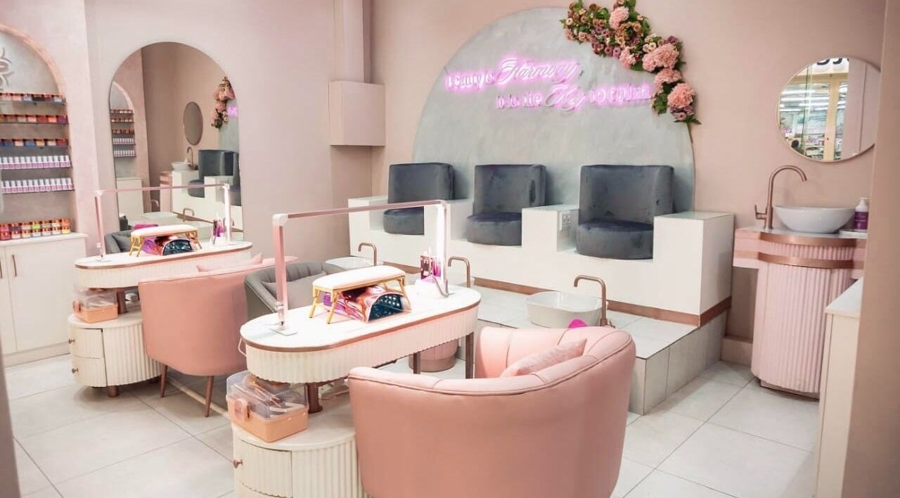 Chic nail salon interior at Harmony Nail & Beauty Morning Glen, Johannesburg, Gauteng, ZA with plush pink seating.