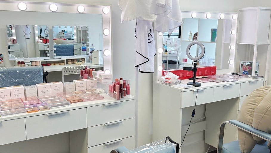 Makeup studio at OBB Personal Colour, London, England, GB, featuring well-lit vanity mirrors and cosmetics.