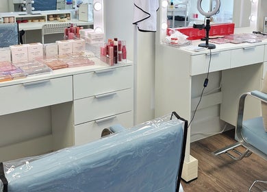 Cosmetics and beauty setup at OBB Personal Colour, London, England, GB with mirrors and makeup products.