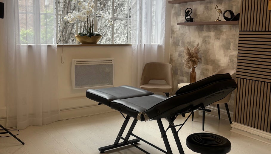 Serene treatment room at Skin Sculptura, Liverpool, England, GB with elegant decor and massage table.