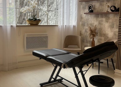Serene treatment room at Skin Sculptura, Liverpool, England, GB with elegant decor and massage table.