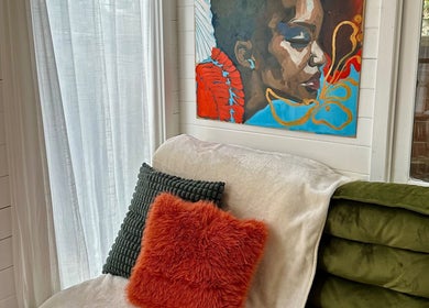 Relaxing corner with vibrant art and cushions at Pinch Nails, London, England, GB.